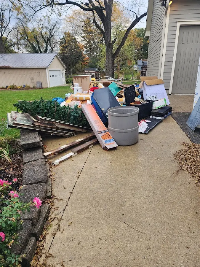 Dumpster being loaded with debris for Estate Cleanout Dumpster Rental in Pleasant Grove